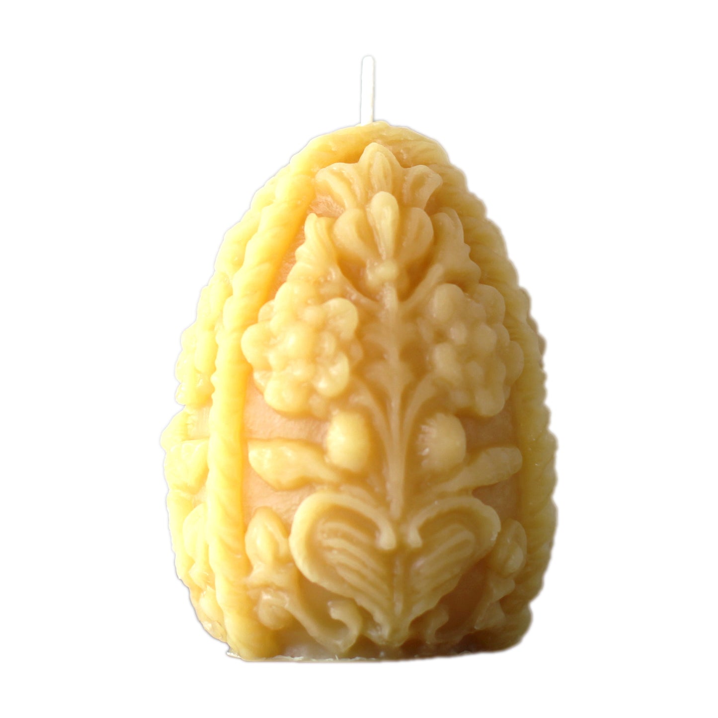 A product photo of a beeswax Easter egg shaped candle on a white background. The egg candle has an ornate decorative design. 